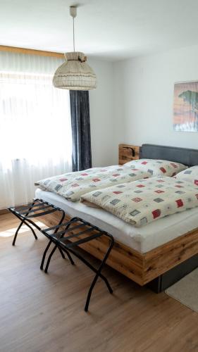 a bed with a quilt on it in a bedroom at Appartement Wurm- nahe Hochzillertal für Familien in Kaltenbach