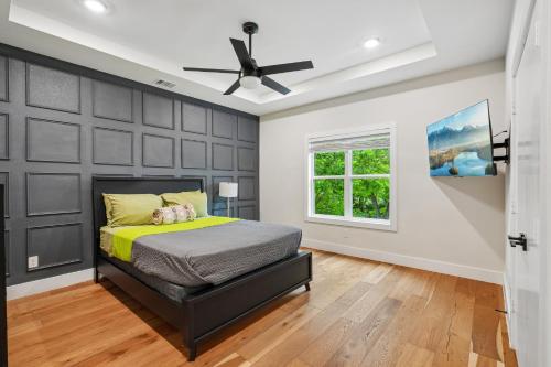 a bedroom with a bed and a ceiling fan at Munice at Trinity Grove in Dallas