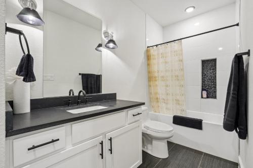 a bathroom with a sink and a toilet at Munice at Trinity Grove in Dallas