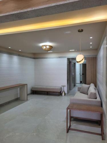 a large living room with a couch and a table at Smart Pituba Studio Premium in Salvador