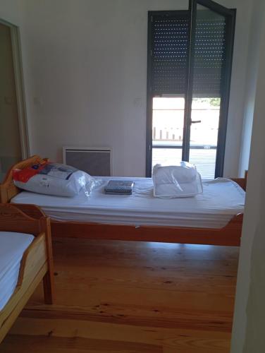 a bedroom with a large bed with white sheets at maison wave in Léon