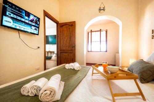 a room with towels on a bed with a tv at ALBA - Seaview Luxury in San Teodoro