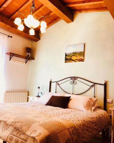 a bedroom with a bed in a room with wooden ceilings at Cipressi Rossi in Greve in Chianti