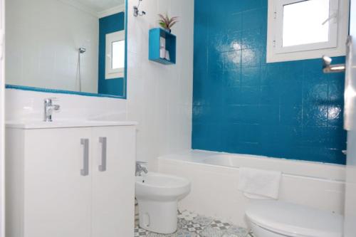 a bathroom with a toilet and a sink and a mirror at Hotel Marazul in Mojácar
