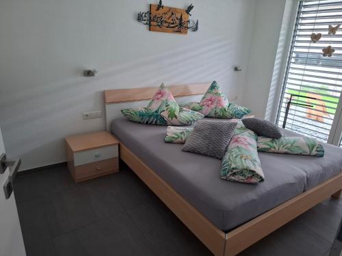 a bed with pillows on it in a room at Apart van der Heyd in Prutz