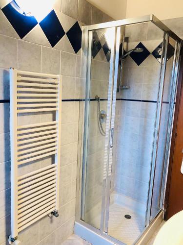 a shower with a glass door in a bathroom at Cipressi Rossi in Greve in Chianti