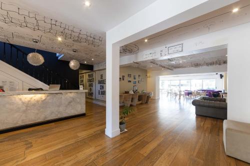 a lobby of a building with a couch and tables at Casa Daupi Hotel Boutique in Mar del Plata