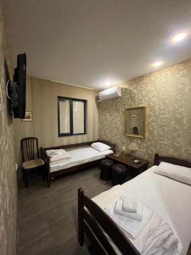 a hotel room with two beds and a sink at Апартамент за гости КРИСИ - Apartment for rent KRISI in Vidin