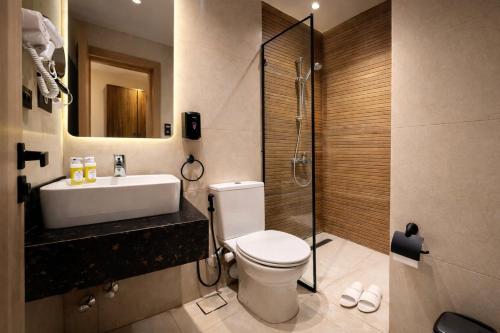 a bathroom with a toilet and a sink and a shower at Cairo Stays Hotel in Cairo