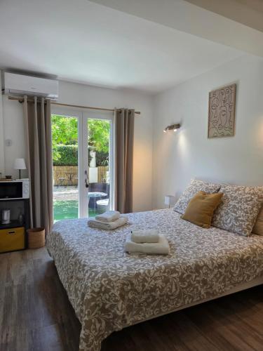 a bedroom with a bed with two towels on it at Chez Louis in Les Issambres