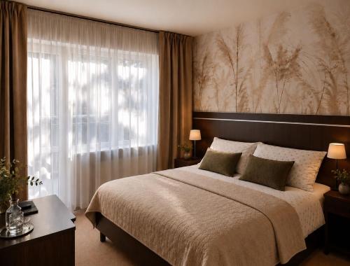 a bedroom with a large bed and a window at Willa Celina in Karpacz