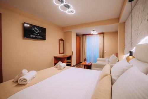 a hotel room with a bed and a couch at Villa Dislievski in Ohrid