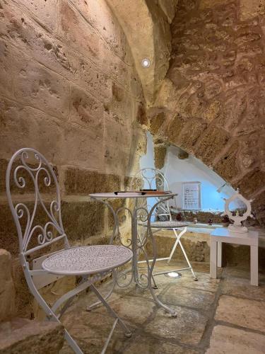 a table and a chair in a stone room at Agrimi b&b in Mesagne