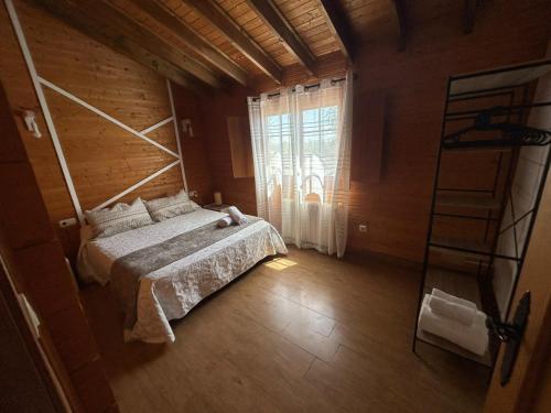 a bedroom with a bed and a window and a ladder at Cabaña con jacuzzi privado in Caravaca de la Cruz