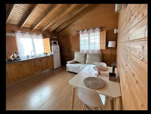 a kitchen and a living room with a table in a room at Cabaña con jacuzzi privado in Caravaca de la Cruz