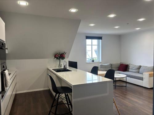 a kitchen and a living room with a couch at Pärnu Lubja Apartments in Pärnu