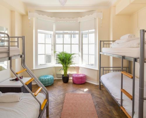 a dorm room with two bunk beds and a window at Pier Court Apartments Brighton in Brighton & Hove