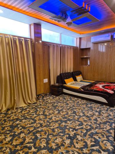 a room with a bed and curtains in it at Hotel Dilli Darbar and Restaurant in Bandipura