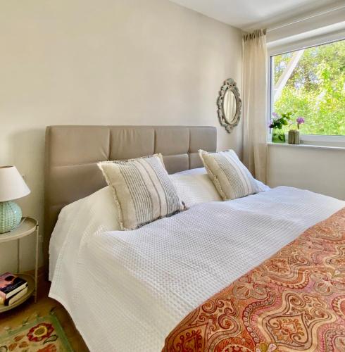 a bedroom with a large bed with a window at "Ellas Home Sekirn" - in 3min am Badestrand in Sekirn