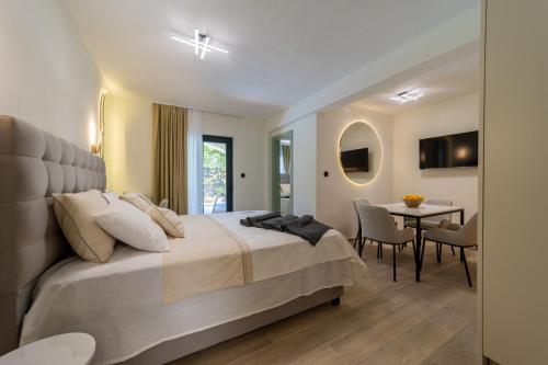 a bedroom with a large bed and a table at Klaris Guest house in Budva