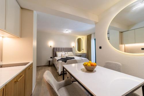 a room with a bed and a table with a bowl of fruit at Klaris Guest house in Budva