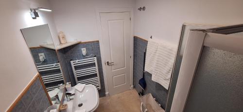 a bathroom with a white toilet and a sink at A & G Casares Costa in San Luis de Sabinillas