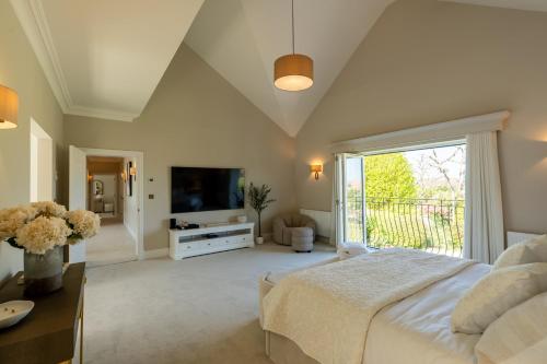 a large bedroom with a bed and a large window at Sea Estate House in Littlehampton
