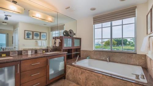 a large bathroom with a tub and a large window at 311 Mariners Club in Key Largo