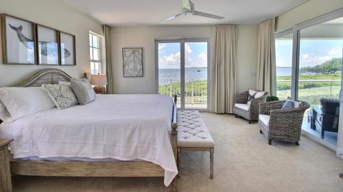 a bedroom with a bed and a view of the ocean at 311 Mariners Club in Key Largo
