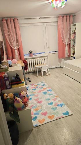 a room with a bedroom with a rug and a crib at Cozy Stay Širvintos in Širvintos