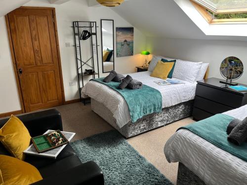 a bedroom with two beds and a mirror at Scarisbrick Apartment Sleeps 6 in Scarisbrick