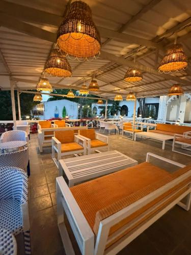 a restaurant with orange and white tables and chairs at ART Sattal in Bhīm Tāl