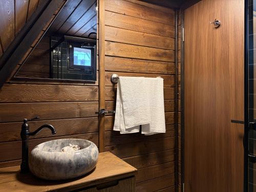 a bathroom with a stone sink in a cabin at Bona Dea in Cayeli