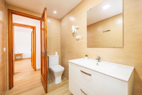 a bathroom with a white sink and a toilet at Apartamento Felipe 1-4 in Cala d´Or