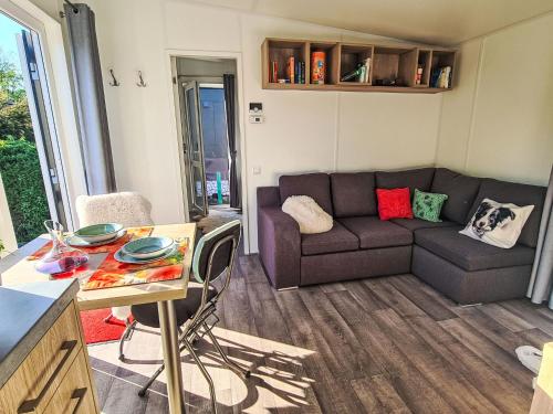 a living room with a couch and a table at Holiday Home Tiny Haus Heidi by Interhome in Beilngries