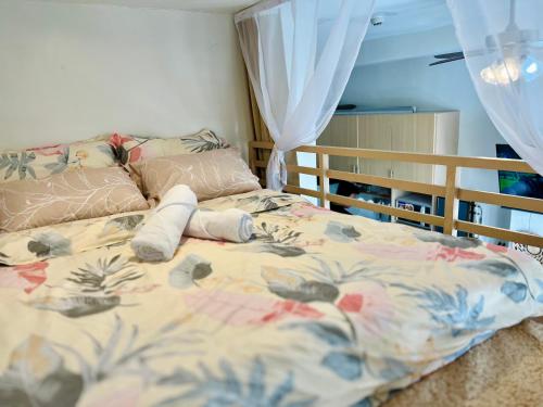 a bedroom with a bed with a bedspread with a foot board at Cozy Loft Studio with Balcony in Cebu City in Cebu City