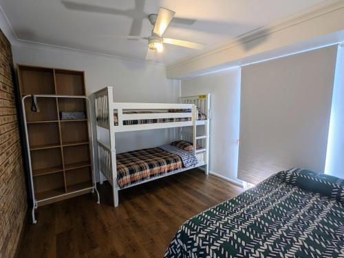 a bedroom with two bunk beds and a bed at 3-Bed home with large backyard in Mandurah