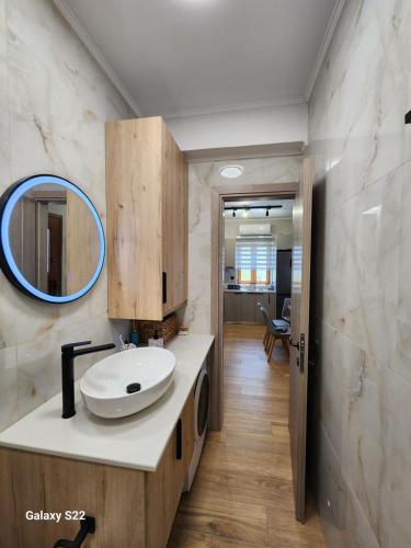 a bathroom with a sink and a mirror at Annie's cozy home in Mythimna