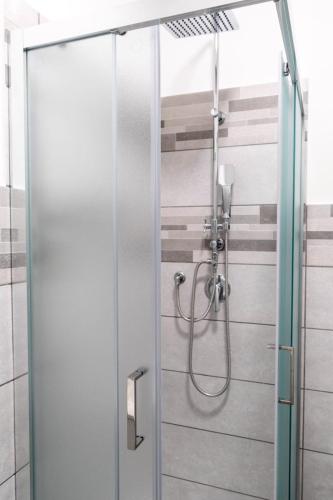 a shower with a glass door in a bathroom at Prestige House 6 in Scalea