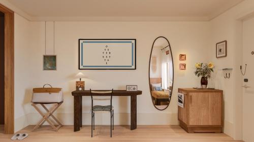 a room with a table and a mirror on a wall at Oyster Estate in Greenport