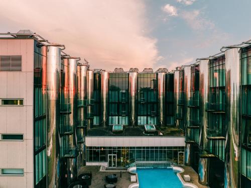 a building with a swimming pool in front of it at Tallink Spa & Conference Hotel in Tallinn