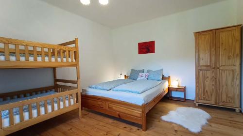 a bedroom with a bunk bed next to a bunk bed gmaxwell gmaxwell gmaxwell at Wellness apartmán TERASA in Bozkovska