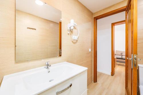 a bathroom with a white sink and a mirror at Apartamento Felipe 1-3 in Cacla D'or