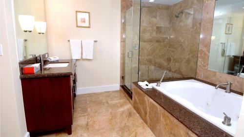 a bathroom with a large tub and a shower at 333 Mariners Club in Key Largo