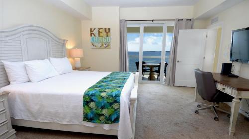 a bedroom with a bed and a desk and a computer at 333 Mariners Club in Key Largo