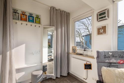 a living room with a window and a chair at Ferienhaus am See mit Boot in Mustin
