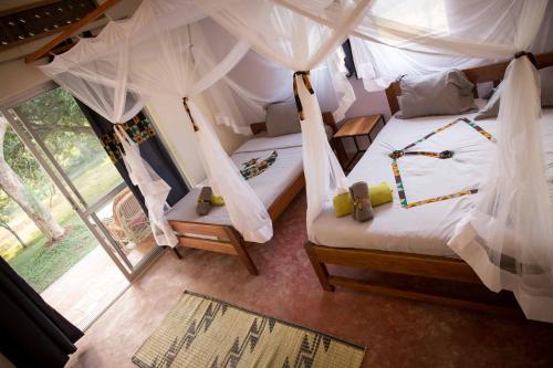 A bed or beds in a room at ViaVia Entebbe