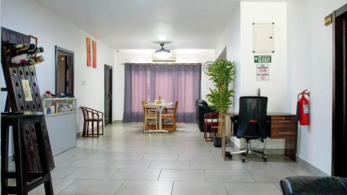 a living room with a table and chairs at My dad's cottage in Sekondi-Takoradi