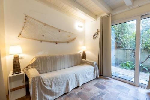 a bedroom with a bed and a large window at Sibilla house 2 in Olbia