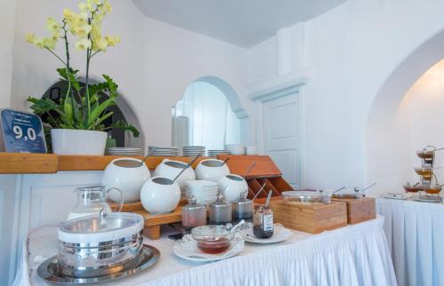 a table with a bunch of items on it at Hotel Adonis in Mýkonos City